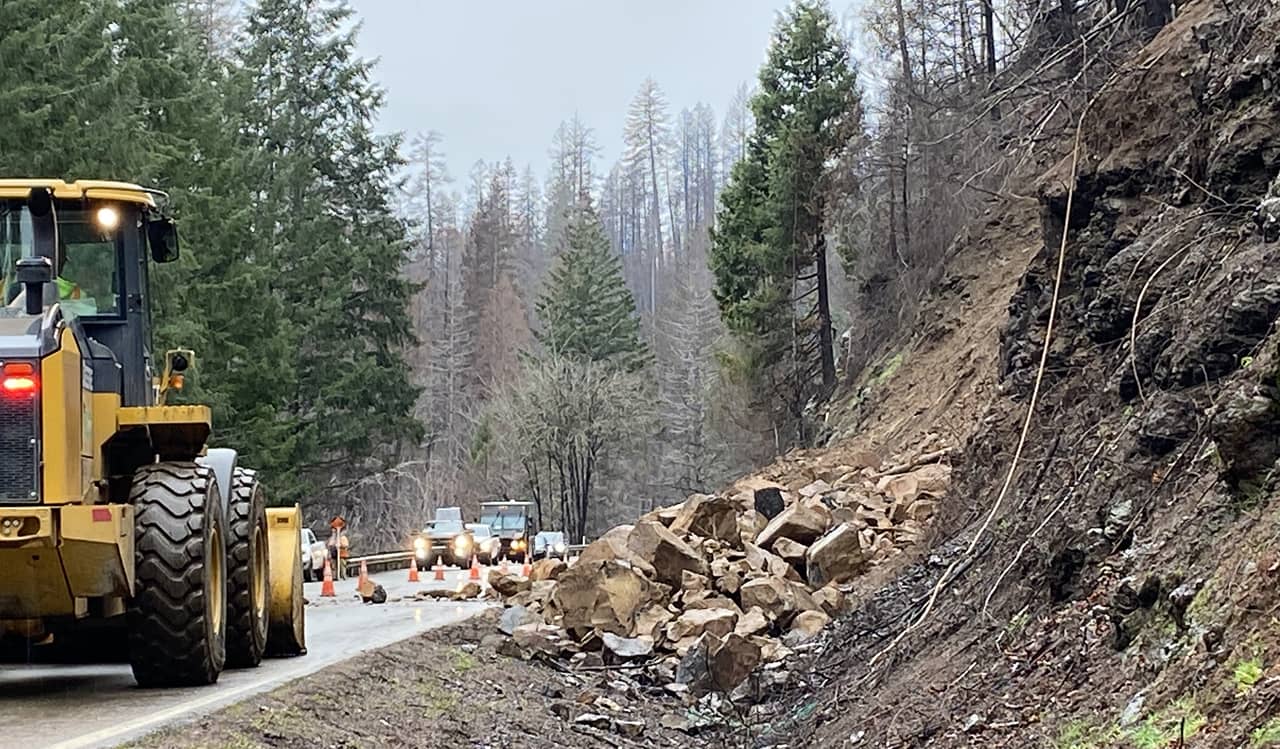 A photo of a rockfall mitigation process along a roadway